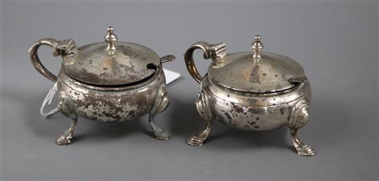 A pair of 1960s silver mustard pots and two associated silver spoons.